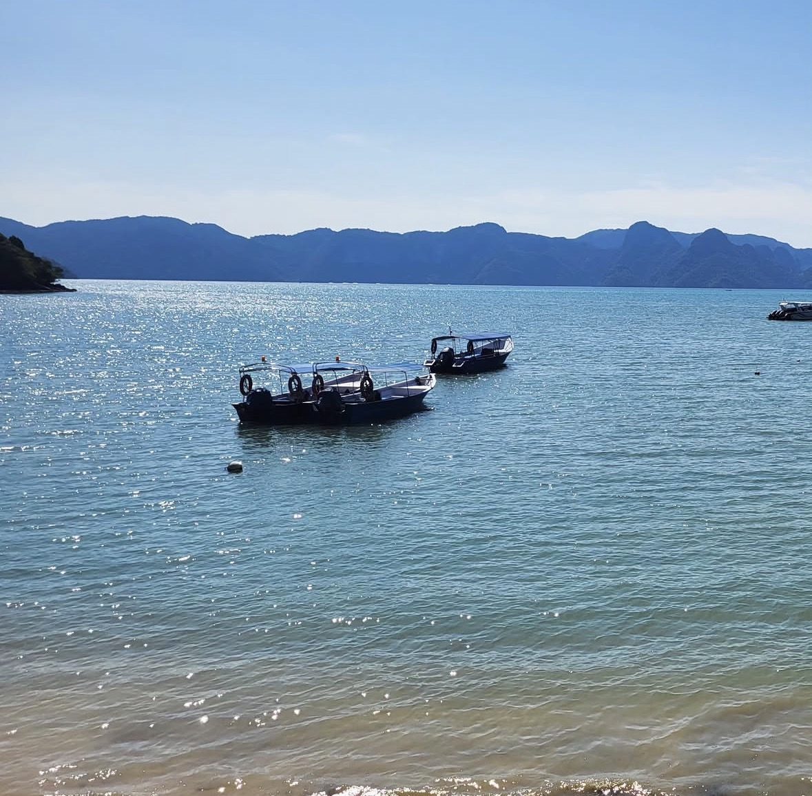 Local guide on boat sharing tips during island hopping tour langkawi experience